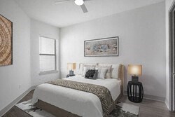 a white bedroom with a bed and a window