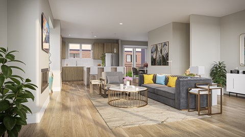 A modern townhome living room with a grey sofa and a wooden floor.