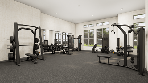 A black and white image of a gym with various exercise equipment.