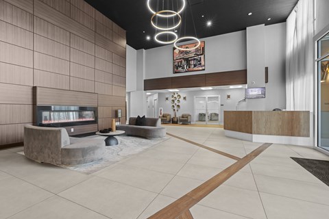 A modern lobby with a reception desk and a television.