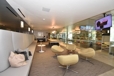 A modern living room with a white couch and a television.