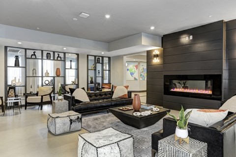 A modern resident lounge with a fireplace and a variety of seating options.