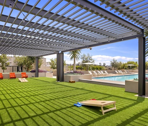 A patio with a pool and a table.