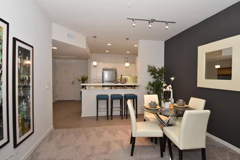 Dining area with kitchen and bar seating at Casa Mira View Apartments, California