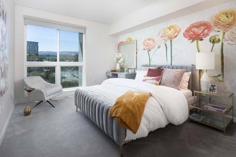 Bedroom with floral wall mural and gray upholstered bed at Elements Apartments, California, 92612