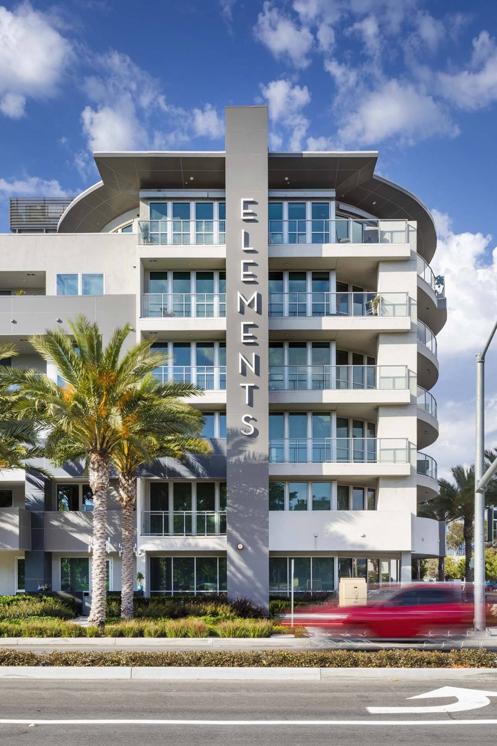A modern building with the name "SENE" on a pillar in front.
