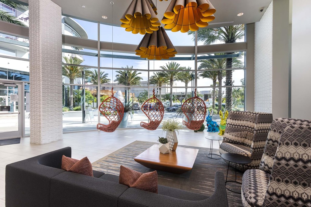 A modern living room with a large window and a wooden coffee table.