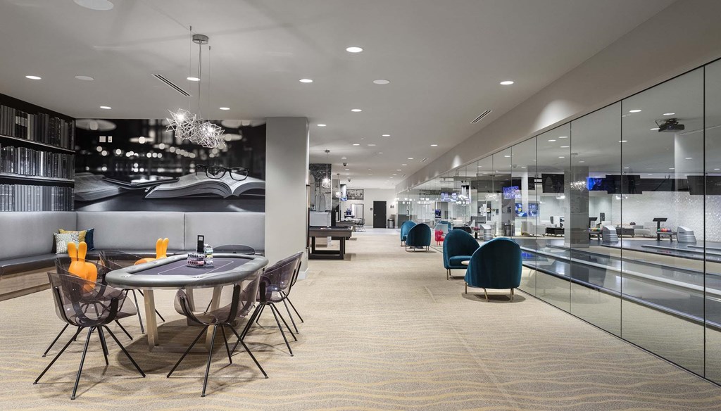 A modern dining area with a glass wall separating the kitchen from the dining area.