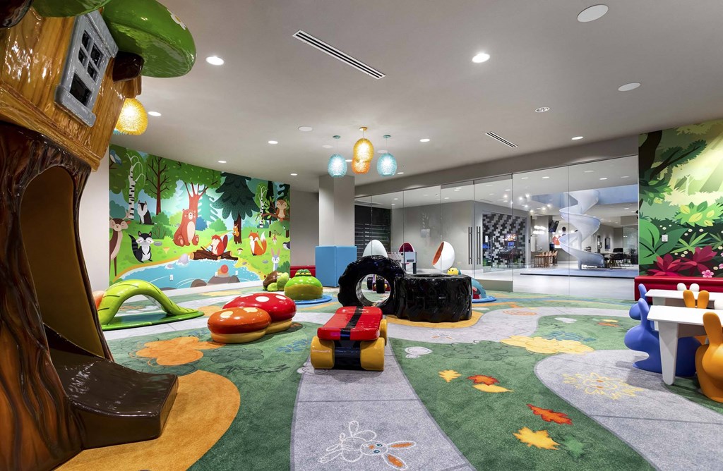 A colorful children's play area with a tree-shaped chair and a slide.