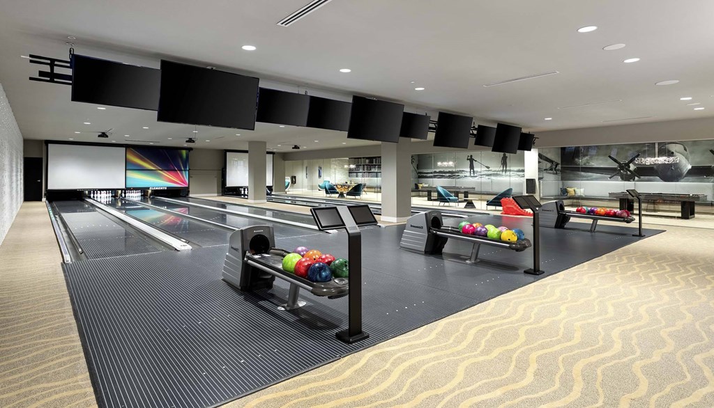 A bowling alley with lanes and bowling balls.