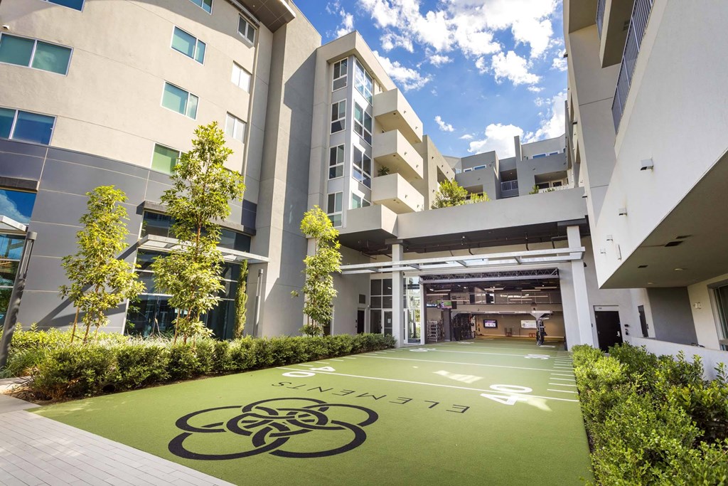 A modern building with a green lawn in front.