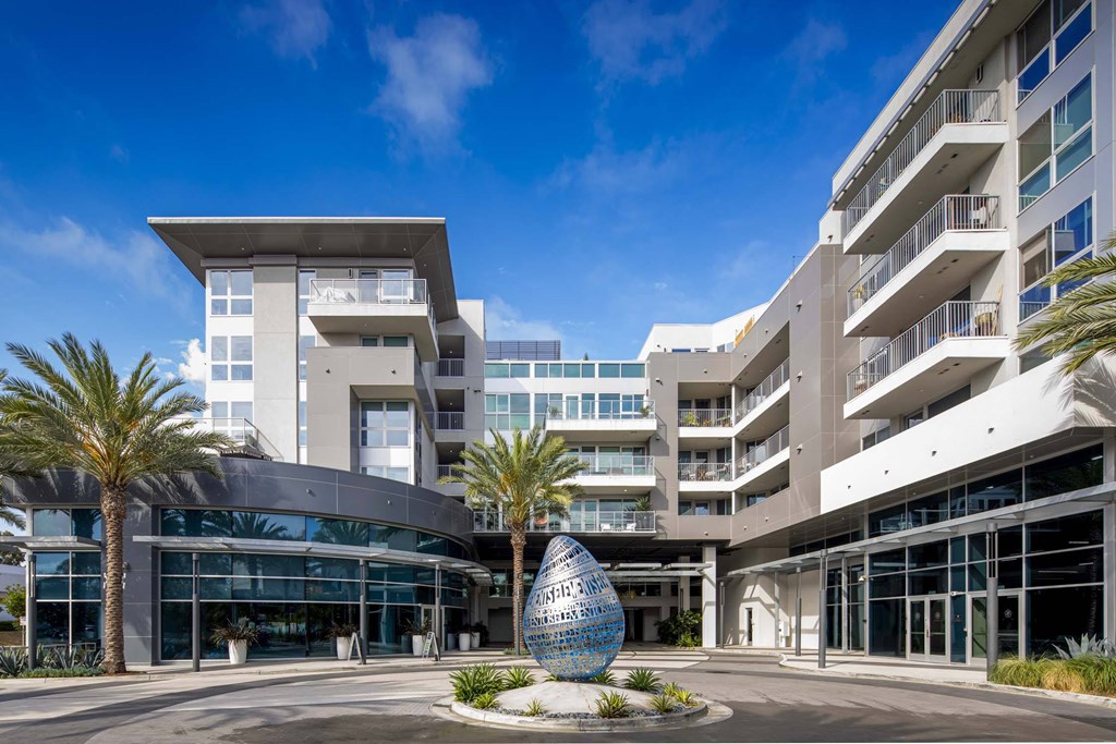 A modern building with a large sculpture in front of it.
