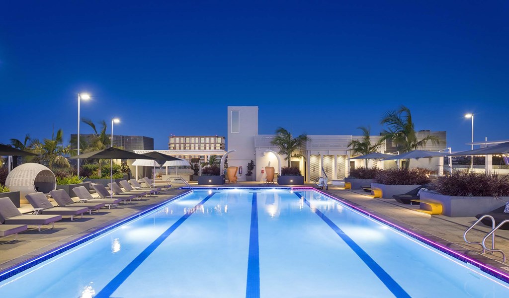 A large indoor swimming pool with lane markers and sun loungers.