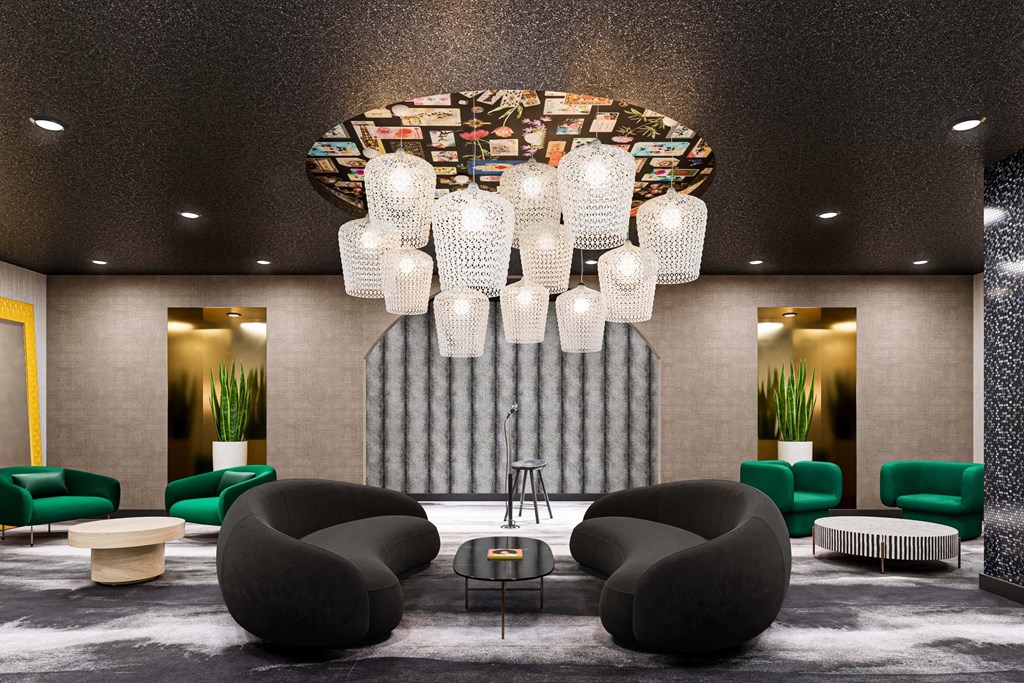 A modern lounge area with a large chandelier and comfortable seating.