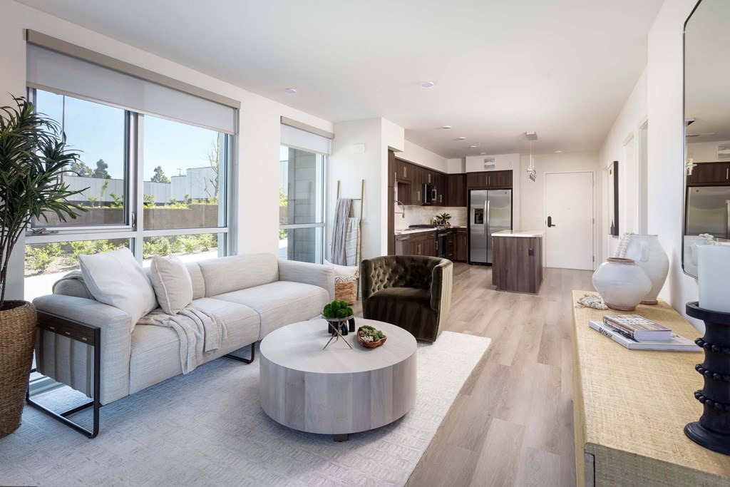 A modern living room with a large sectional sofa and a coffee table.