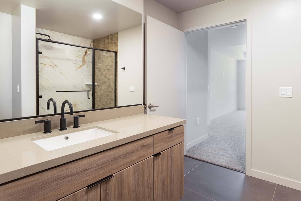 A bathroom with a sink and mirror.