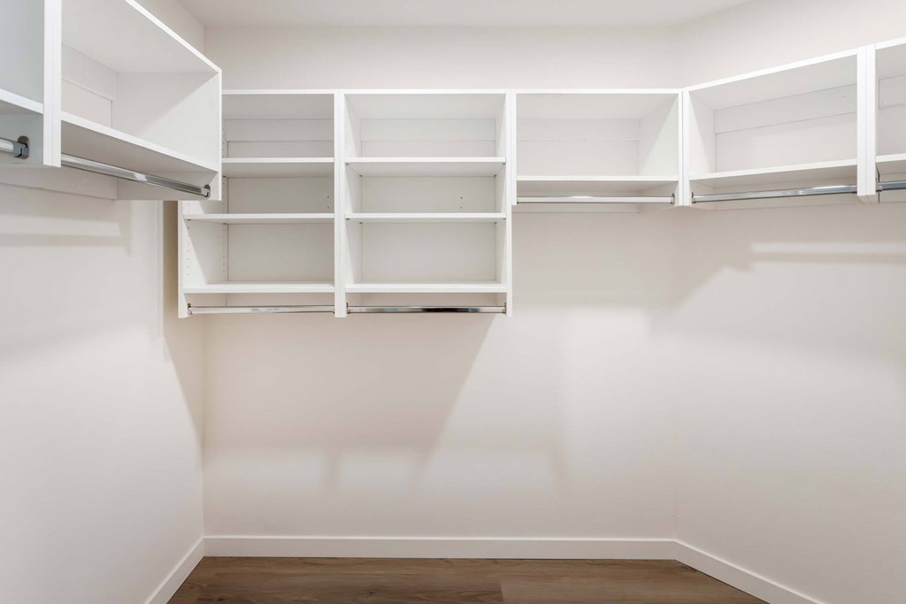 A white closet with shelves and drawers.
