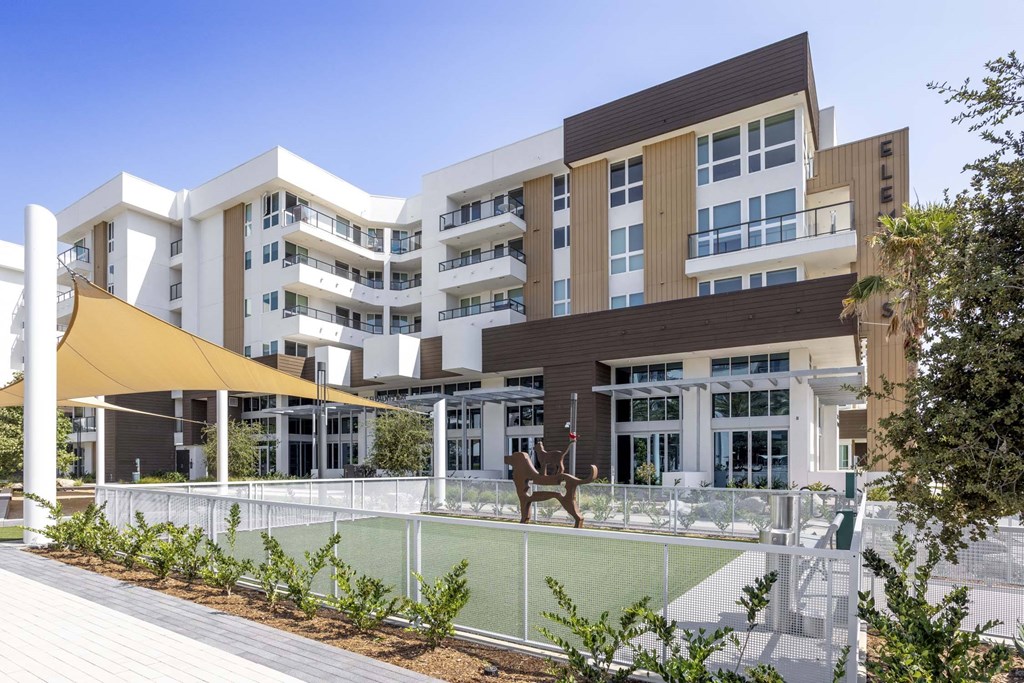 A modern building with a playground in front.