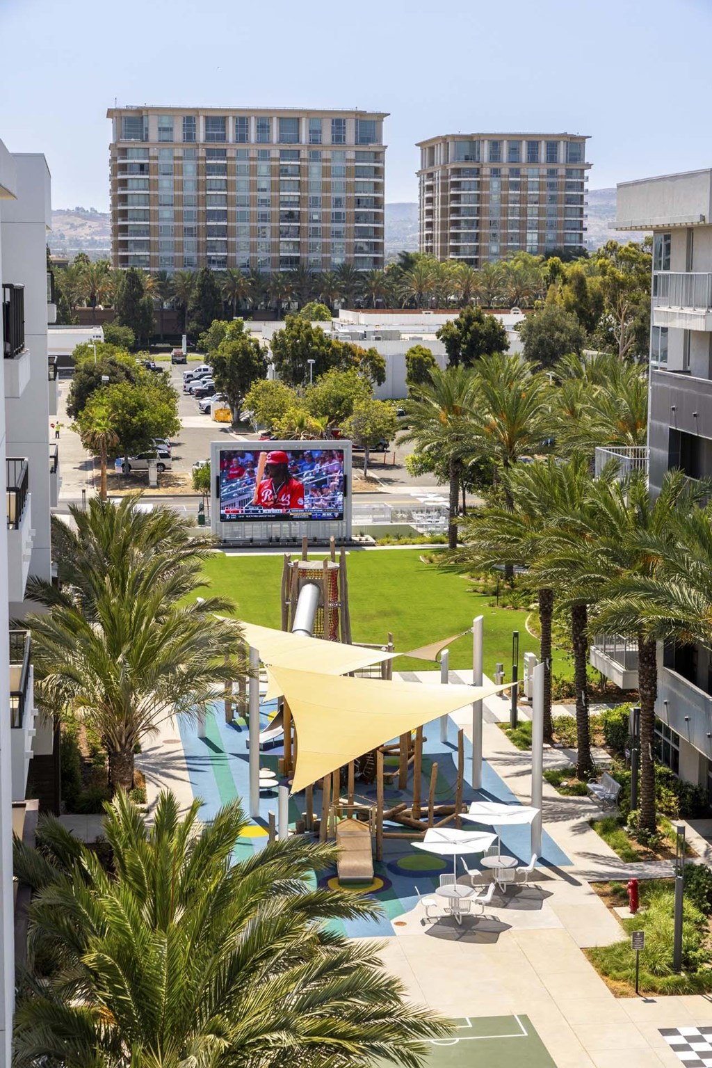 A pool area with a slide and a screen.