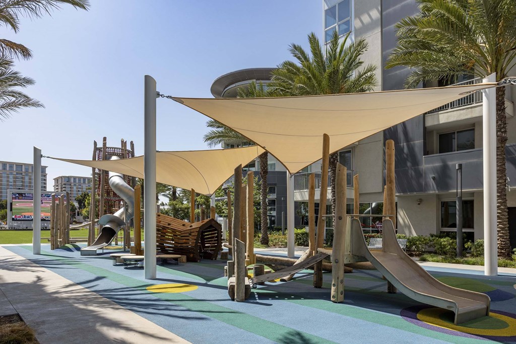A playground with a slide and a wooden structure.