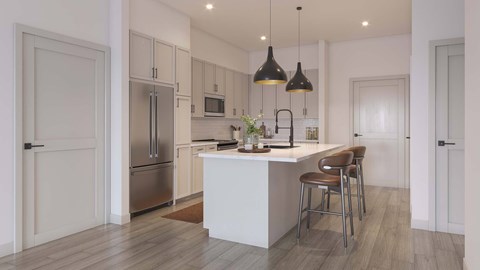 A modern kitchen with a white island and stainless steel appliances.