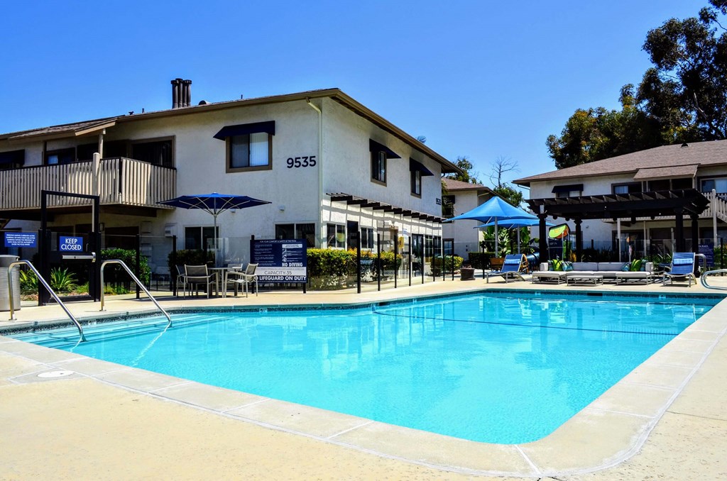 A swimming pool in front of a building at La Jolla Canyon Apartments, California