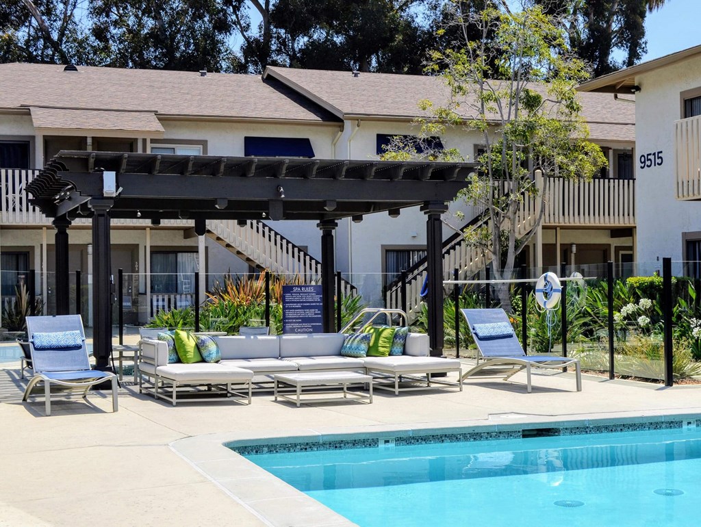 A pool area with sun loungers and a pergola.at La Jolla Canyon Apartments, San Diego