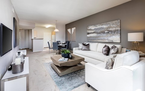 A modern living room with a white couch and a coffee table.
