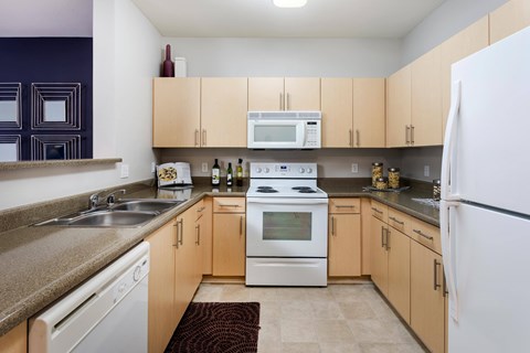 A kitchen with a white oven and refrigerator.