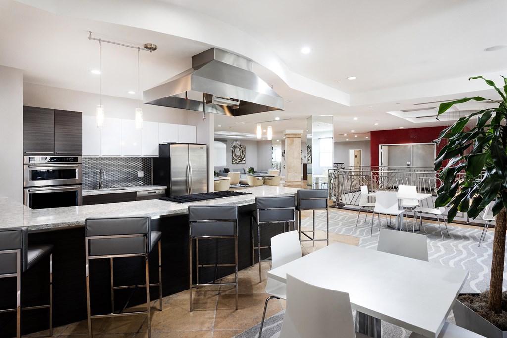 A modern kitchen with black and white appliances and furniture. at La Jolla Crossroads Apartments, California, 92122