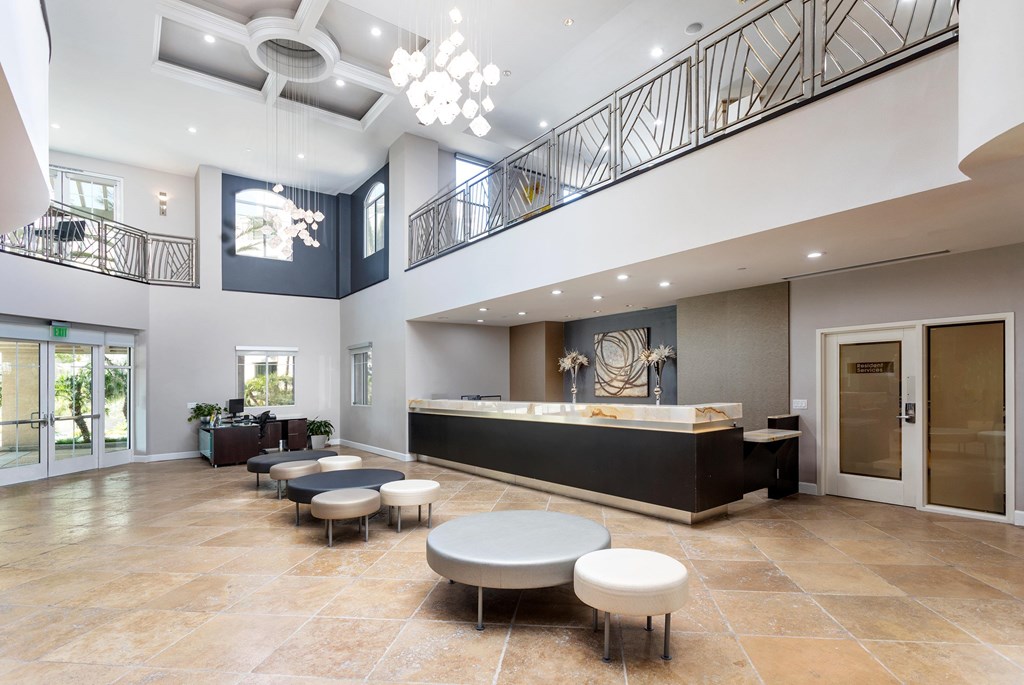 A spacious lobby with a reception desk and seating area. at La Jolla Crossroads Apartments, California