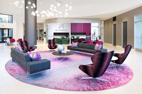 A modern living room with a round sofa and chairs.