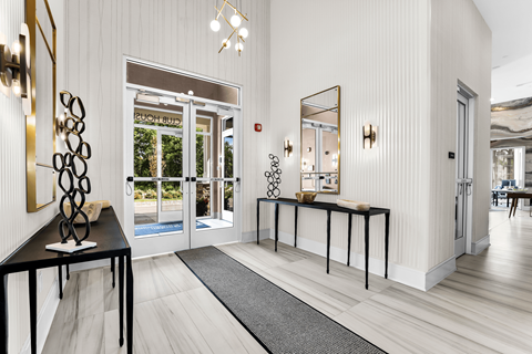 Lobby entrance with a black table and a mirror.