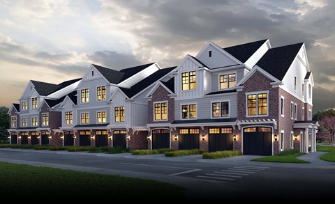 A large, modern house with multiple garages and bright windows.
