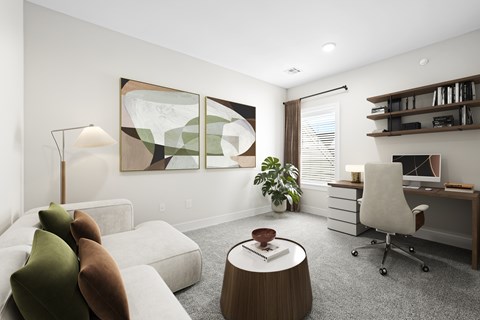 A modern living room with a white couch, a wooden coffee table, and a large abstract painting on the wall.