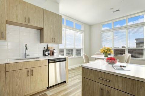 A kitchen with wooden cabinets and a white countertop.