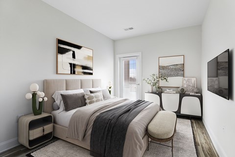 A bedroom with a large bed and a painting on the wall.