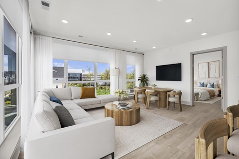 A modern living room with a white sofa and a wooden coffee table.