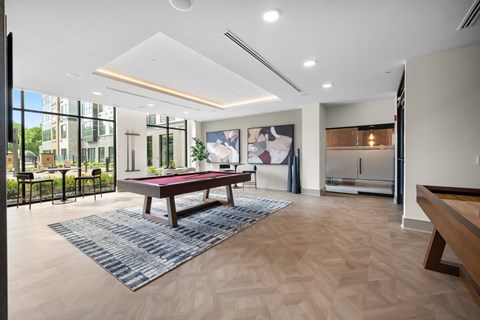 A room with a pool table and a view of the outside.