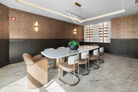 A business center with an oval table and chairs.