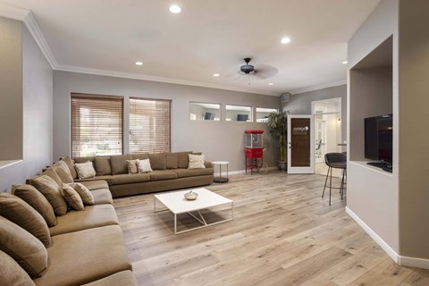 A living room with a brown sofa and a white coffee table.