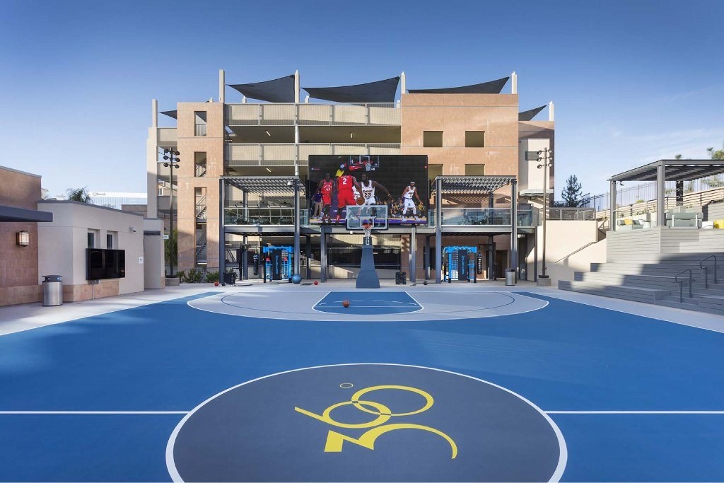 A basketball court with a wheelchair symbol painted on it.