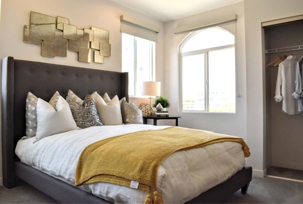 A bedroom with a large bed and a wall art.