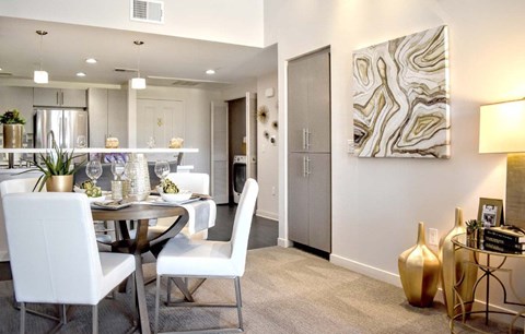 Dining area with contemporary furniture and gold decor at 360 Luxury Apartments, San Diego, 92122