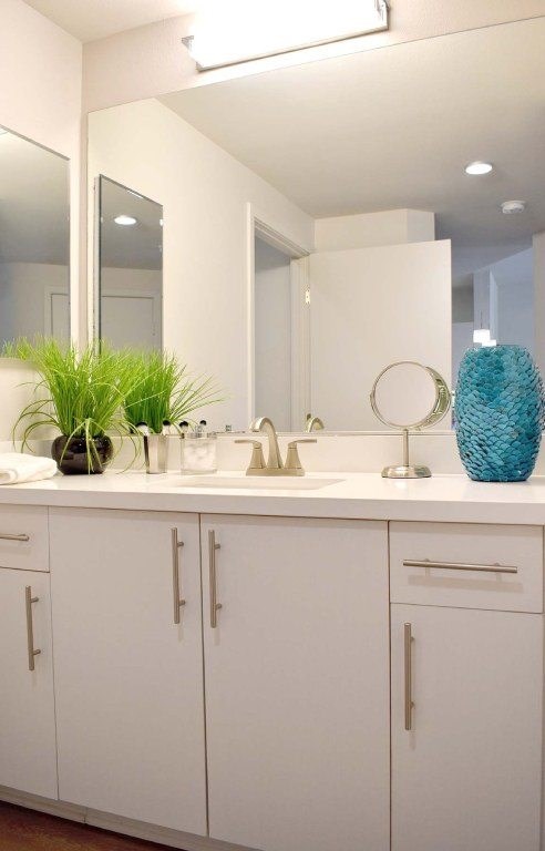 A bathroom with two sinks and a large mirror.