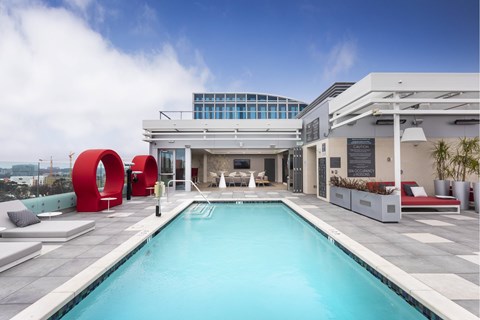 Rooftop pool deck with seating at LUX by Garden* Apartments, California, 92122