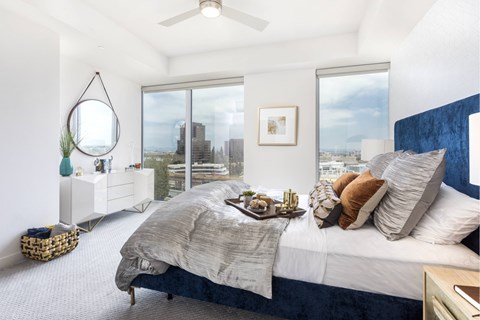 Bright bedroom with city views and modern decor at LUX by Garden* Apartments, California