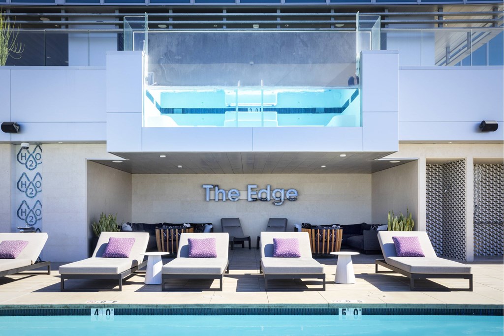 A pool area with lounge chairs at LUX by Garden*, San Diego, California