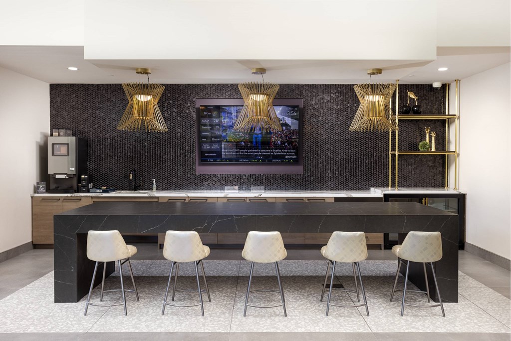 A black and white kitchen with a bar and four chairs. at LUX by Garden*, California