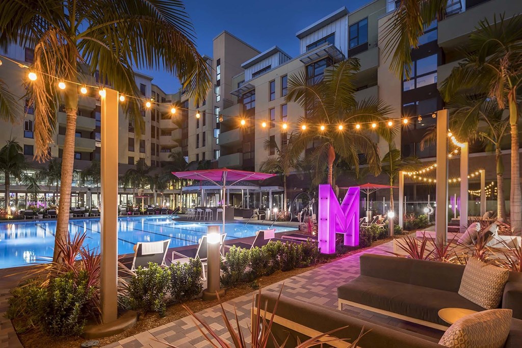 A poolside area with a large M-shaped light decoration.